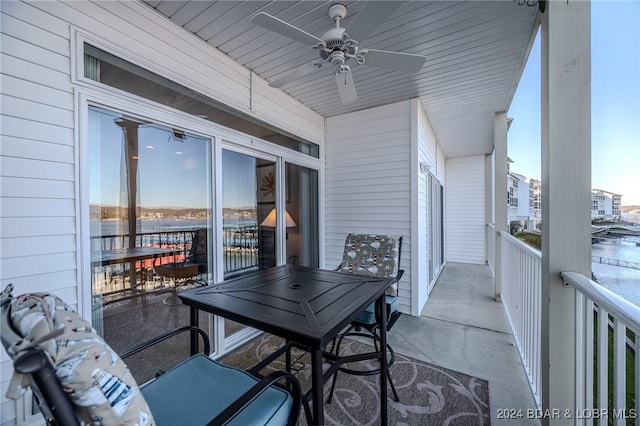 balcony with a water view and ceiling fan