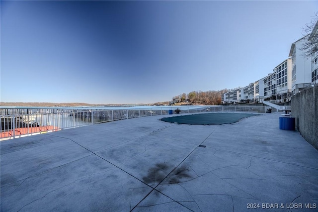 view of swimming pool featuring a water view