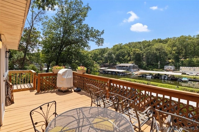 wooden terrace featuring a grill