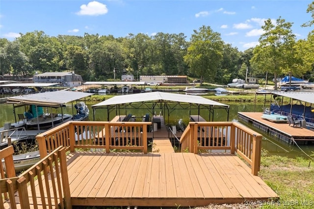 wooden deck with a boat dock and a water view