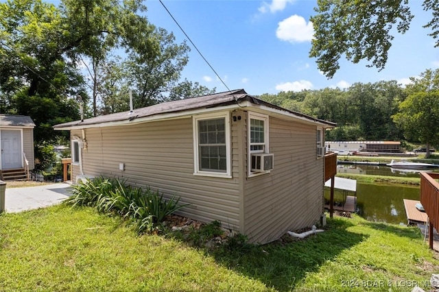 view of property exterior with cooling unit and a lawn