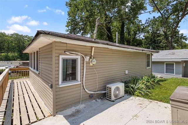 view of side of property featuring ac unit and a patio