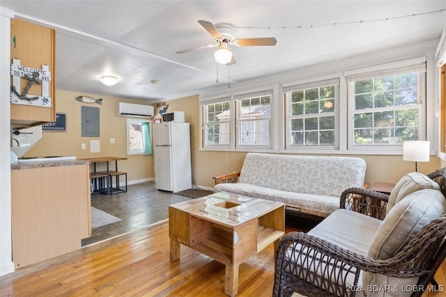 living room featuring wood-type flooring, electric panel, a wall mounted AC, and ceiling fan