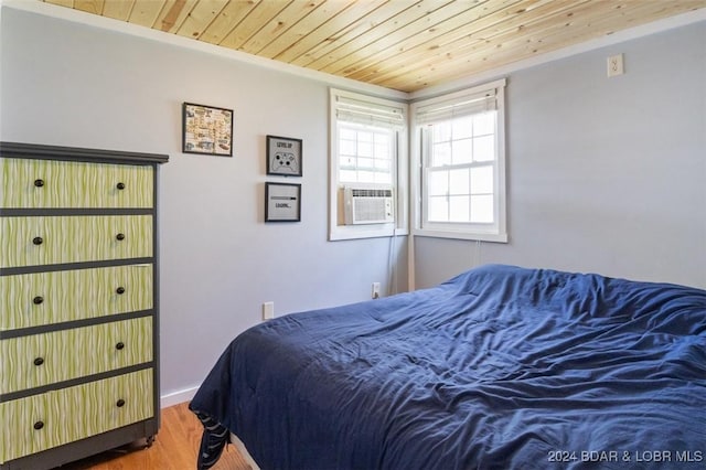 bedroom with hardwood / wood-style floors and wooden ceiling