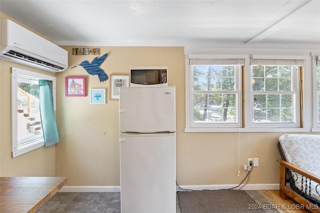 kitchen featuring white refrigerator and a wall unit AC