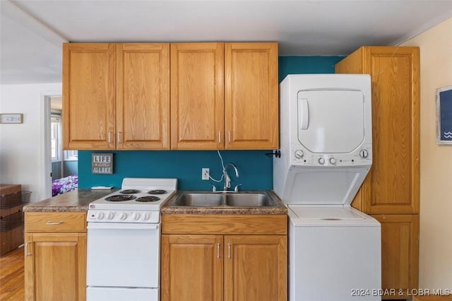 kitchen featuring white range with electric stovetop, sink, light hardwood / wood-style floors, and stacked washer and clothes dryer