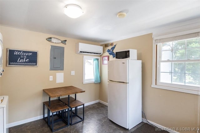 kitchen featuring a wall unit AC, white appliances, and electric panel