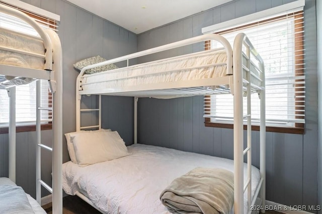 bedroom with wooden walls