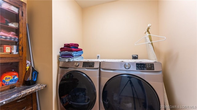 clothes washing area with washer and dryer