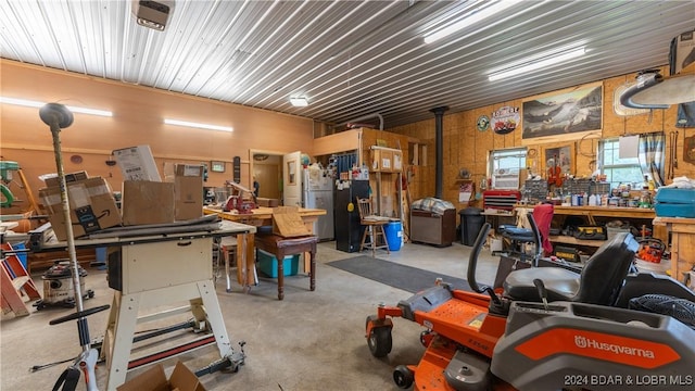 garage with a workshop area and wood walls