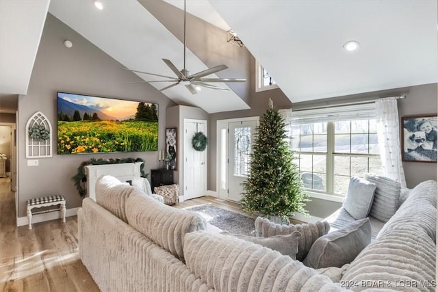 living room with ceiling fan, high vaulted ceiling, and light hardwood / wood-style floors