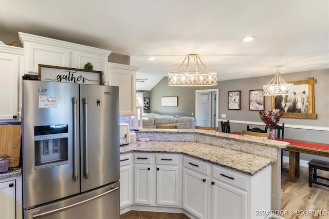 kitchen with stainless steel refrigerator with ice dispenser, light hardwood / wood-style floors, white cabinetry, and pendant lighting