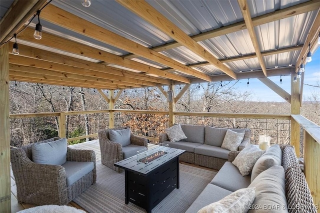 wooden terrace featuring an outdoor living space with a fire pit