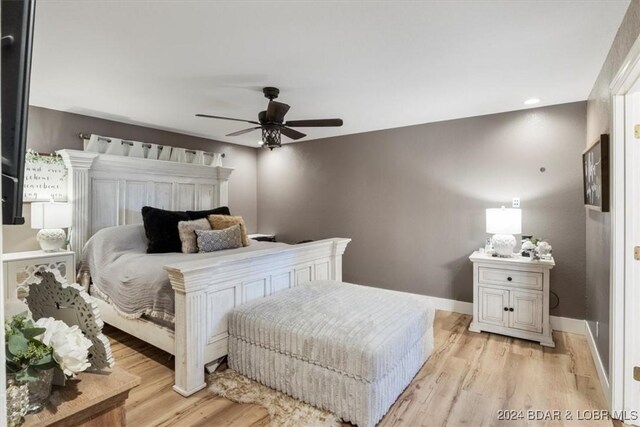 bedroom with light hardwood / wood-style floors and ceiling fan