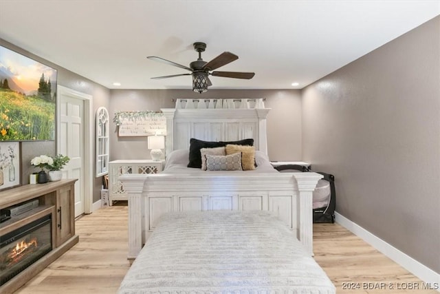 bedroom with light wood-type flooring and ceiling fan