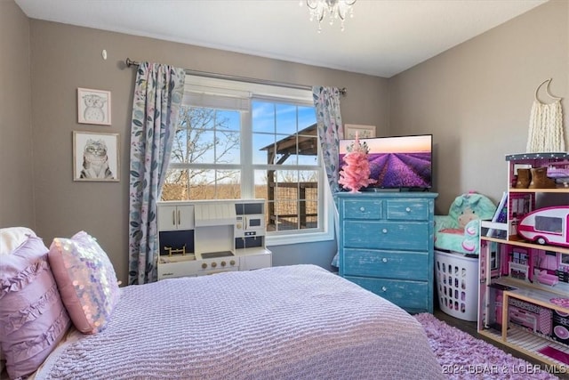 bedroom featuring a notable chandelier