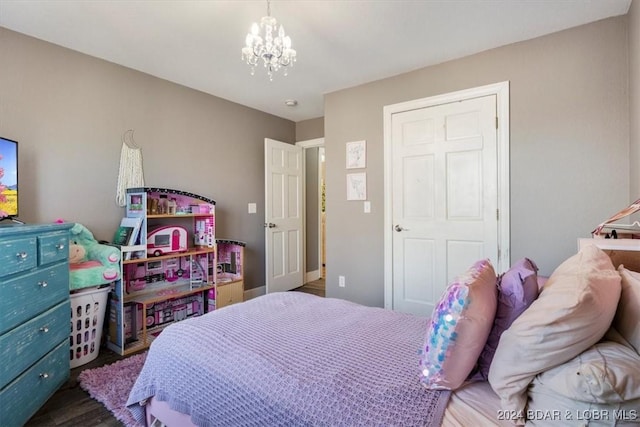 bedroom featuring dark hardwood / wood-style floors and a chandelier