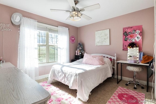 bedroom featuring light colored carpet and ceiling fan