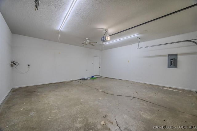 garage featuring electric panel, a garage door opener, and ceiling fan