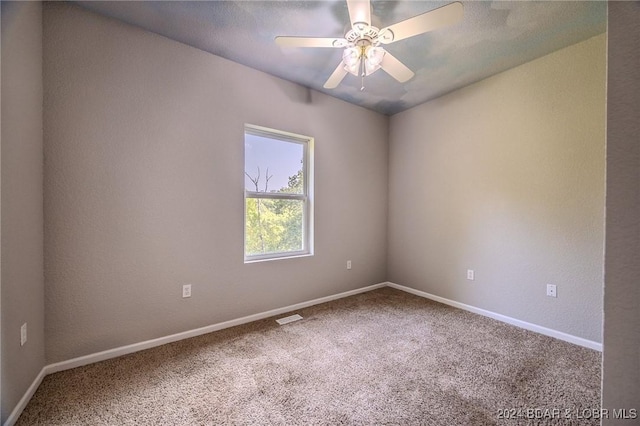 empty room with carpet and ceiling fan