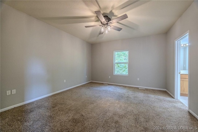 carpeted empty room featuring ceiling fan