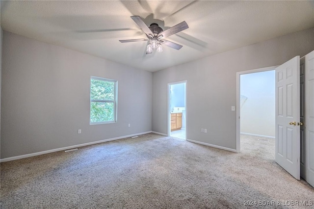 empty room featuring light carpet and ceiling fan