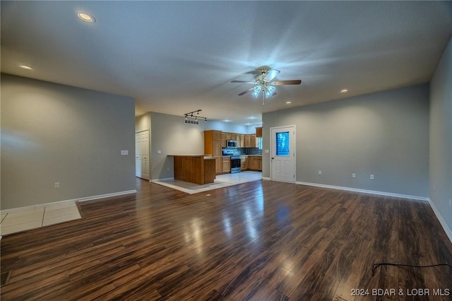 unfurnished living room with ceiling fan and dark hardwood / wood-style floors