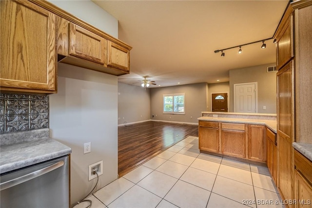 kitchen with backsplash, ceiling fan, dishwasher, and light wood-type flooring