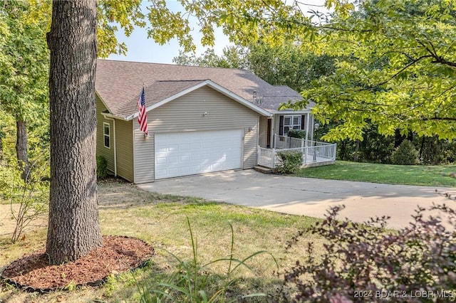 view of front of property featuring a garage and a front lawn