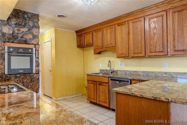 kitchen with light stone countertops, sink, crown molding, light tile patterned floors, and appliances with stainless steel finishes