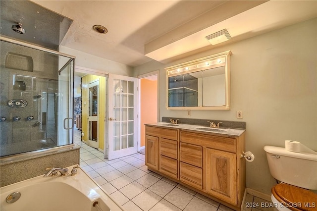 full bathroom with tile patterned floors, vanity, toilet, and independent shower and bath