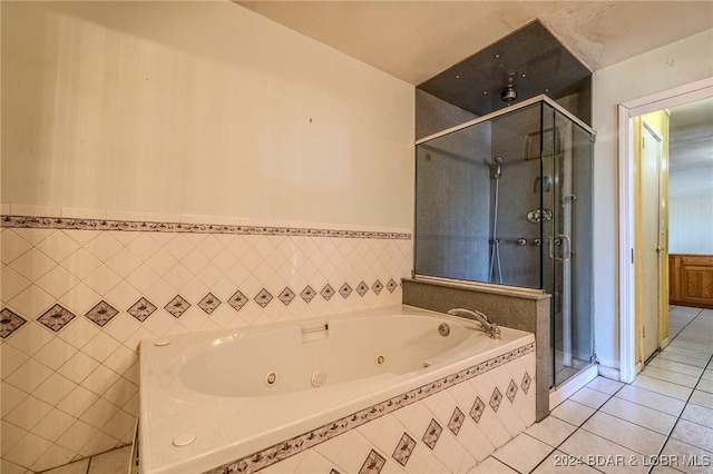 bathroom featuring tile patterned floors, tile walls, and plus walk in shower