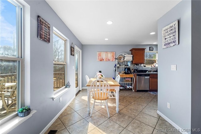 tiled dining space featuring sink