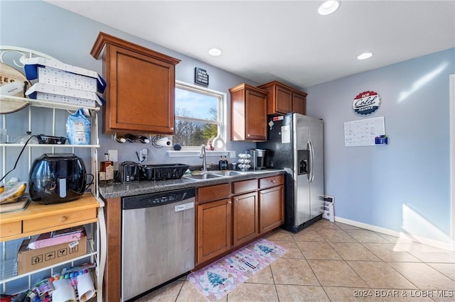 kitchen with sink, light tile patterned floors, and appliances with stainless steel finishes