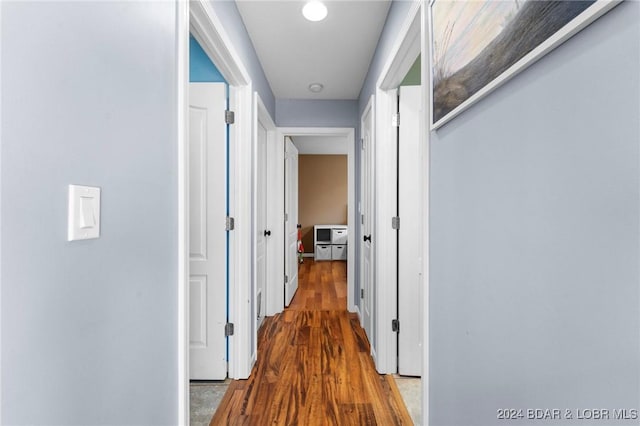 corridor with hardwood / wood-style floors