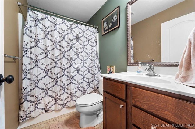 bathroom featuring tile patterned floors, vanity, a shower with shower curtain, and toilet