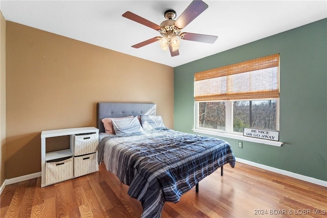 bedroom featuring hardwood / wood-style flooring and ceiling fan