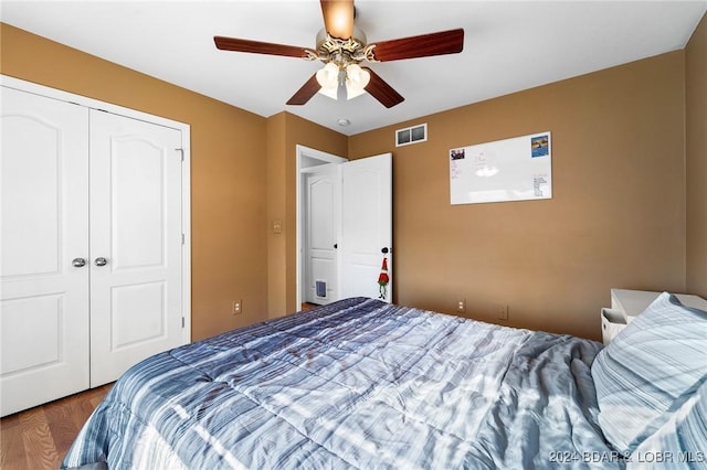 bedroom with a closet, ceiling fan, and hardwood / wood-style flooring