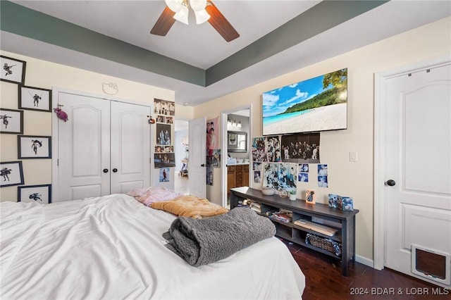 bedroom featuring ceiling fan, dark hardwood / wood-style floors, connected bathroom, and a closet