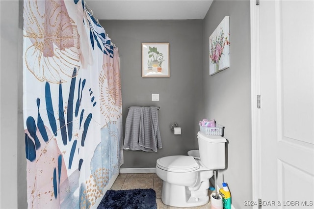 bathroom with tile patterned flooring, a shower with curtain, and toilet