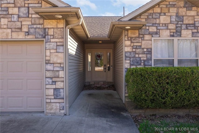 doorway to property with a garage