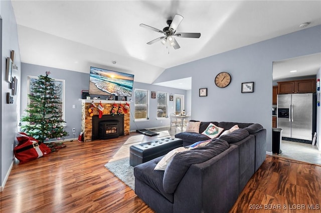 living room featuring ceiling fan, light hardwood / wood-style flooring, and lofted ceiling