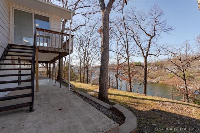 view of yard featuring a carport and a water view