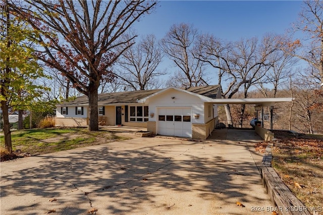 ranch-style house with a garage and a carport