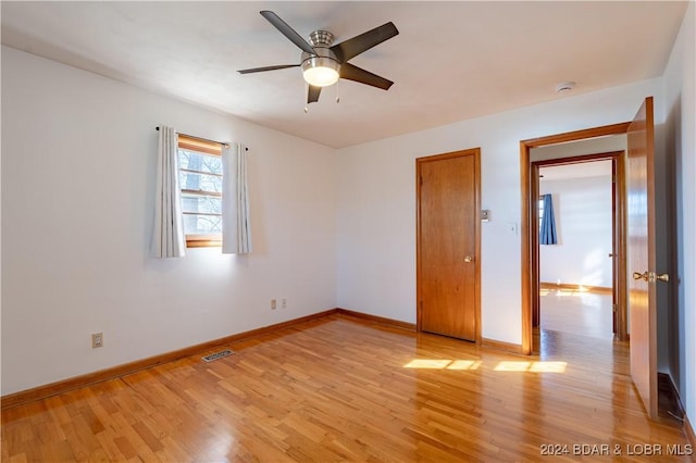 spare room with light hardwood / wood-style floors and ceiling fan