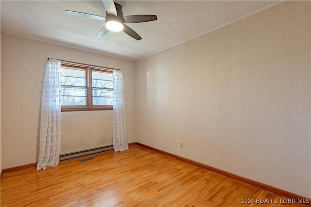 empty room with ceiling fan, ornamental molding, and light hardwood / wood-style flooring