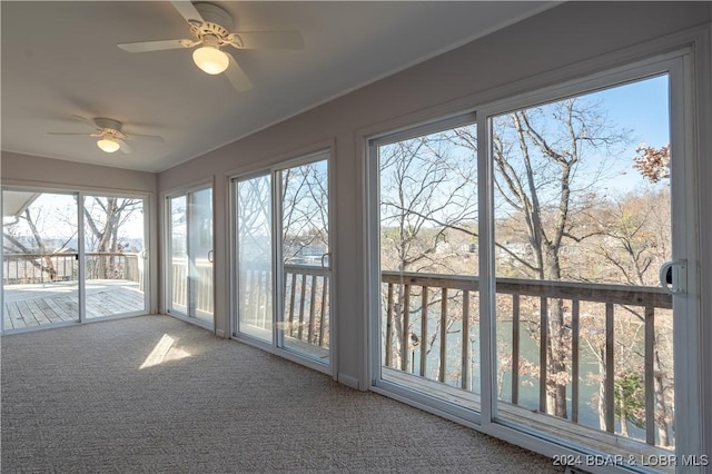 unfurnished sunroom with ceiling fan