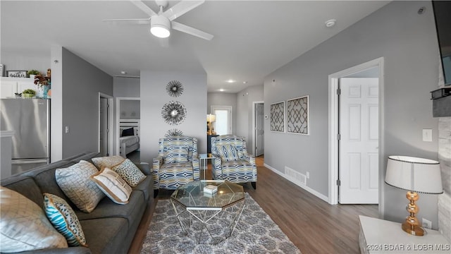 living room featuring wood-type flooring and ceiling fan