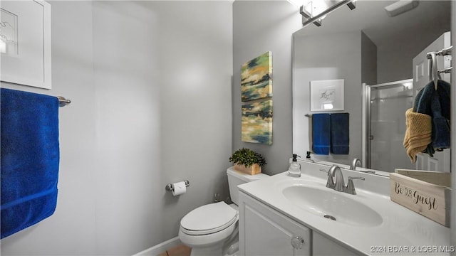 bathroom featuring walk in shower, vanity, and toilet