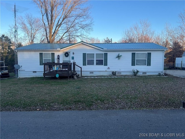 view of front of property with a front lawn and a wooden deck